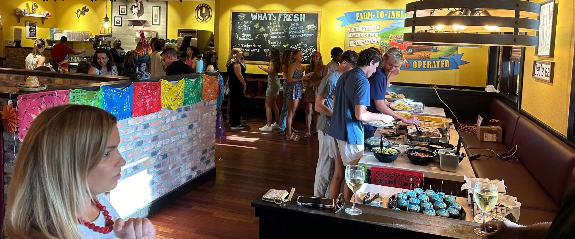 Guests serving themselves from a catered buffet spread inside a Berry Fresh Cafe location