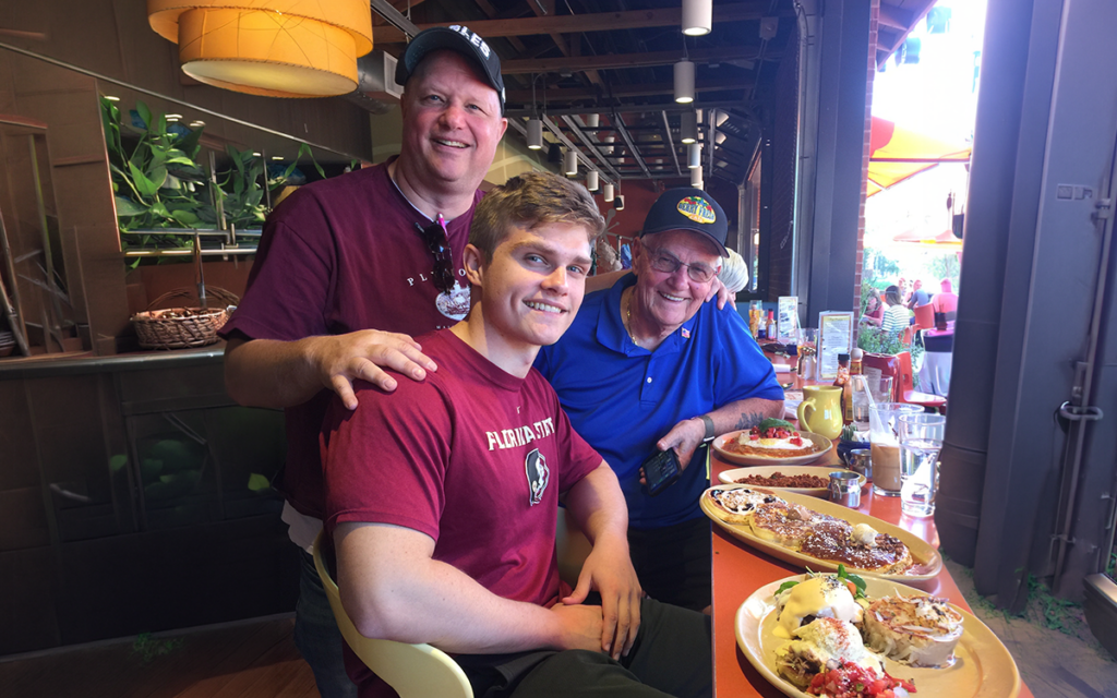 Three generations of the Berry Fresh Cafe family seated at the cafe counter with breakfast plates