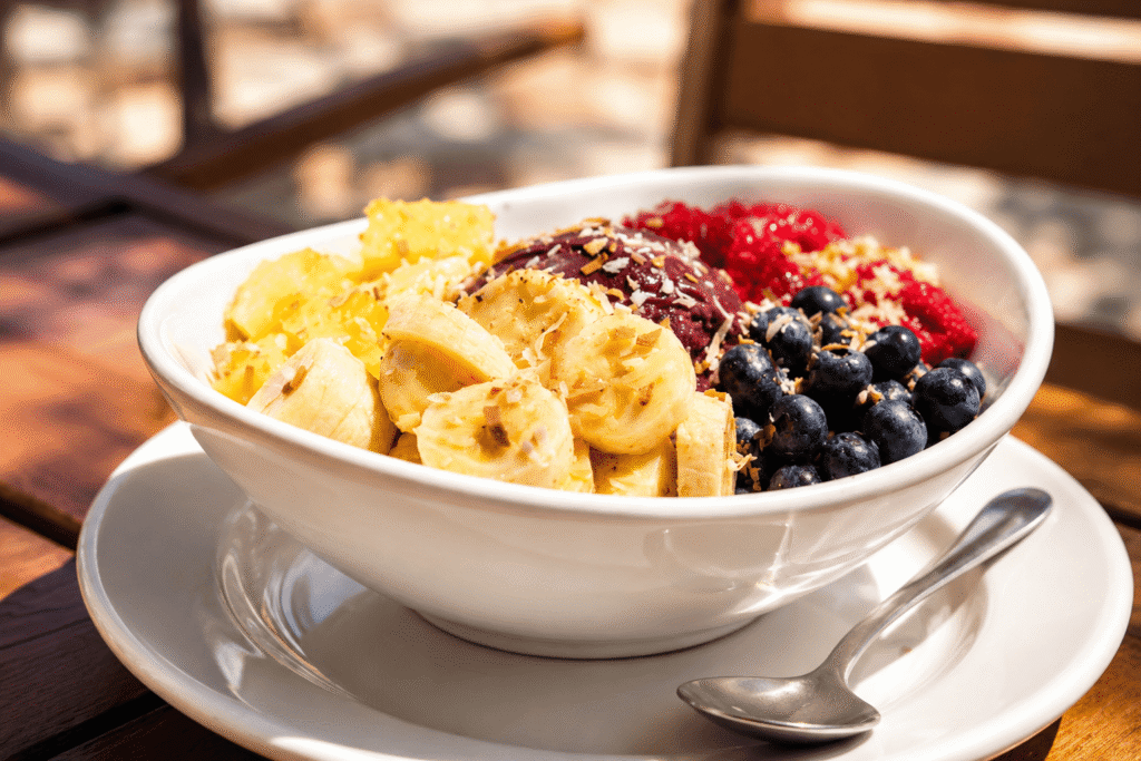 An acai bowl topped with fresh berries, banana and granola